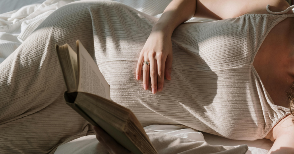 Woman reading a book in bed